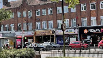 A street view with a row of brick buildings, including a restaurant named 'Orpington Grill & Reubab House'.