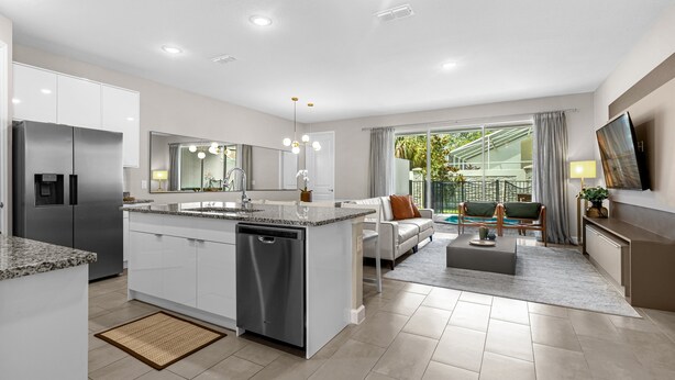 A modern kitchen with a dishwasher, a built-in oven, and a large island with a sink. - 4 BD/ 4 BA/ Formosa Valley (7973 FV) (Kissimmee)