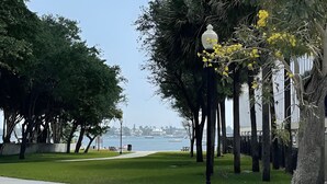 A park pathway with trees and a lamp post. - Hot tub, tiki bar, outdoor shower, water access! (West Palm Beach)