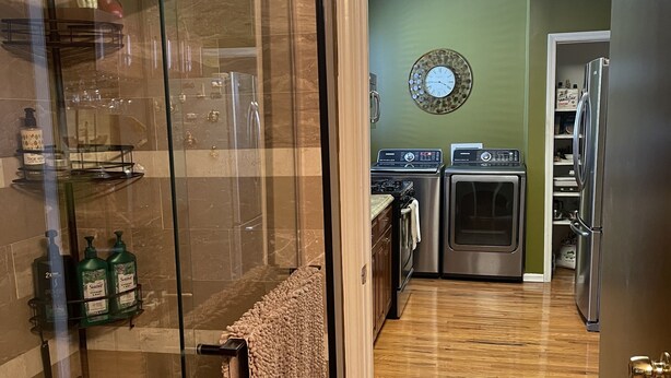A modern kitchen with a glass shower enclosure, a built-in oven, and a refrigerator. - Minutes from Churchill Downs & Downtown Lou! (Louisville)