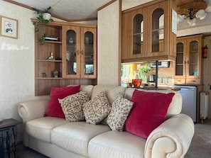 Cozy living room with a leather sofa, wooden cabinetry, and a small table.