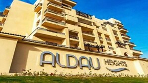 A multi-story hotel named "Aldau Heights" with balconies and a clear sky. - Luxury Apartment in ALDAU HEIGHTS 10204 (Hurghada)