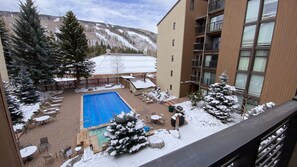 Relax by the pool surrounded by snow-covered trees and scenic mountain views.