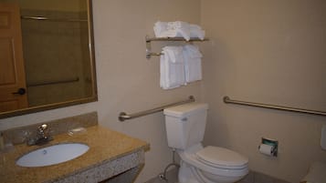 A bathroom with a sink, toilet, and towel rack.