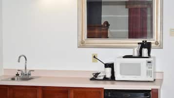 A kitchen with a sink, a microwave, and a coffee maker.