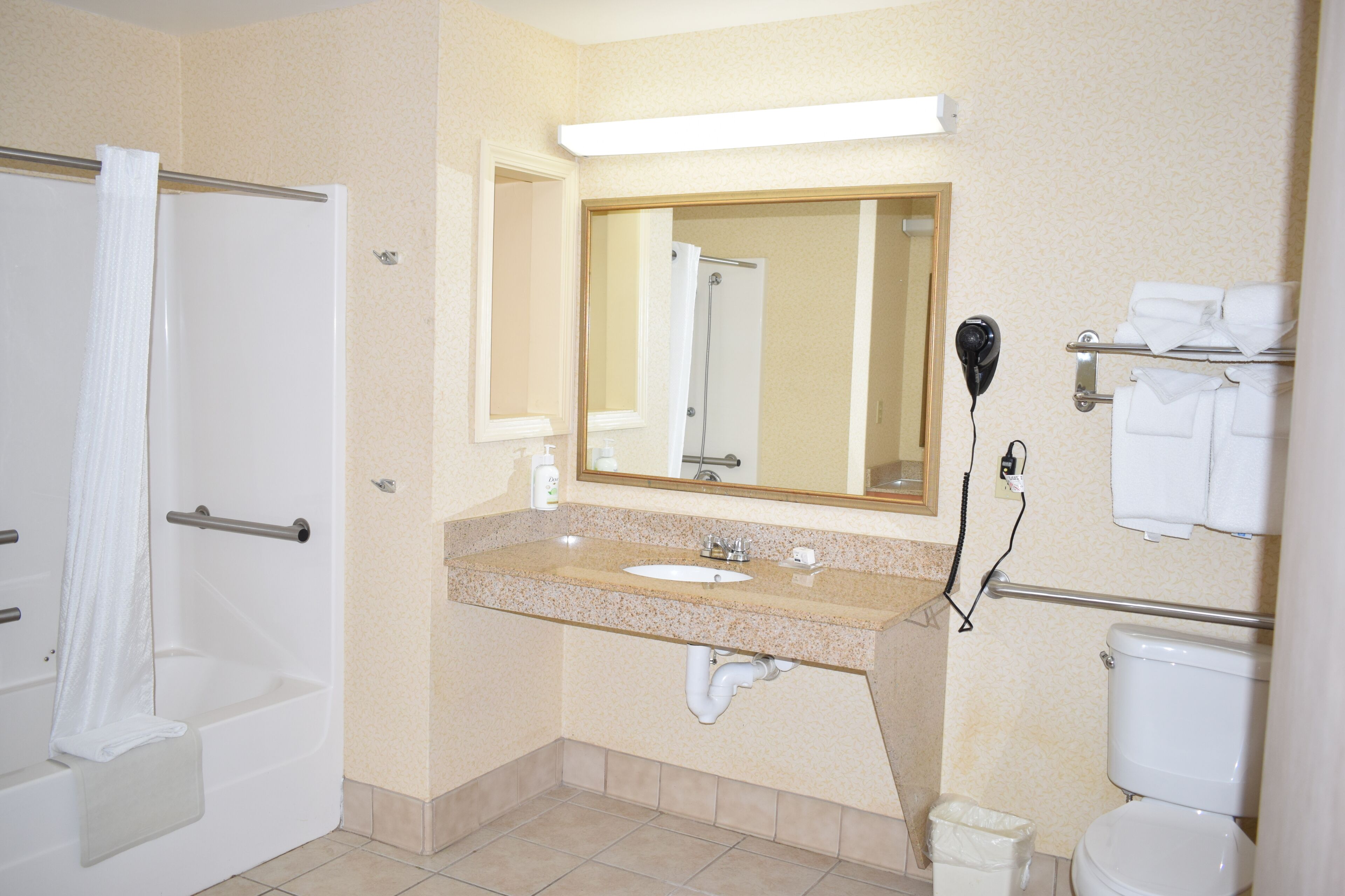deluxe suite, multiple beds, non smoking | bathroom | hair dryer, towels, soap, shampoo