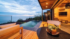 A wooden deck with a pool, outdoor seating, and a view of the sea. - LALOON Luxury Suites - Adults Only, Santa Teresa Beach (Santa Teresa)