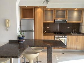 Fridge, oven, toaster, dining tables