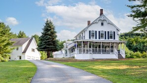 A large white house with a porch and a driveway leading to it. - One-of-a-kind 4 Acre Adirondack Escape Short Drive to LG & GORE Mountain!
 (Warrensburg)