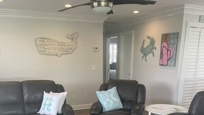 A living room with two leather sofas, a coffee table, and a ceiling fan. - Special Rate Available August 2026 book now (Summerland Key)