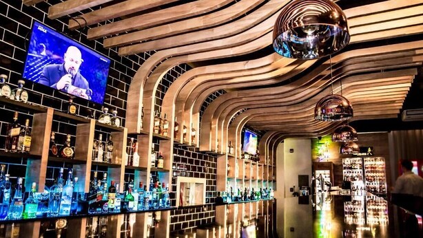A bar with a curved ceiling and shelves of liquor bottles. - 7 Saltos Resort (Salto del Guaira)