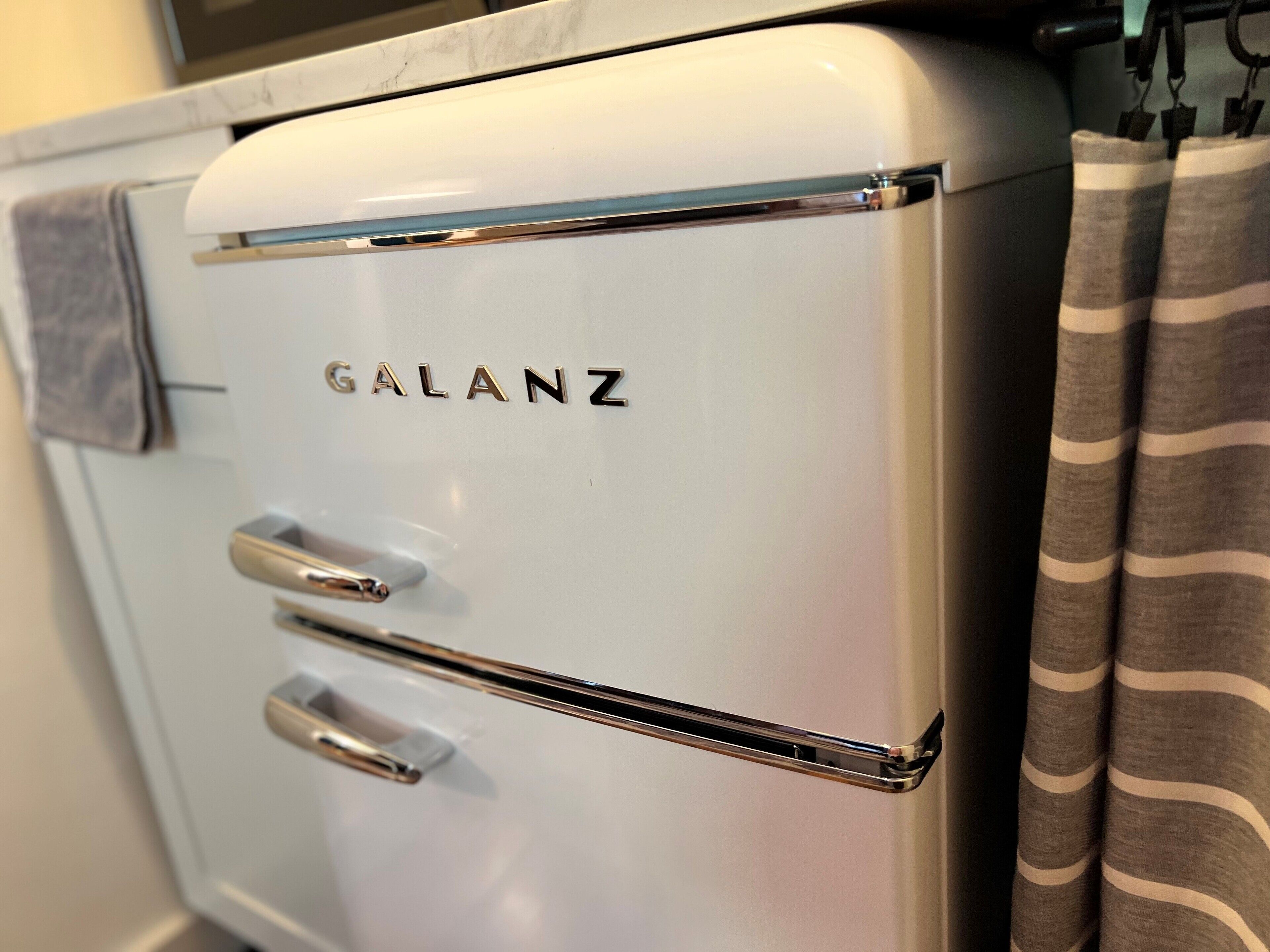 A white Galanz refrigerator with two doors and a metallic handle.