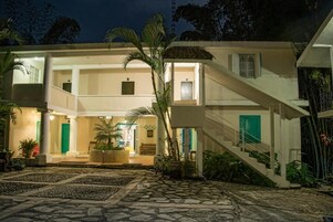 A two-story building with a central courtyard, a staircase, and a well-lit entrance.