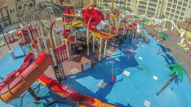 A water park with multiple slides and a pool area.