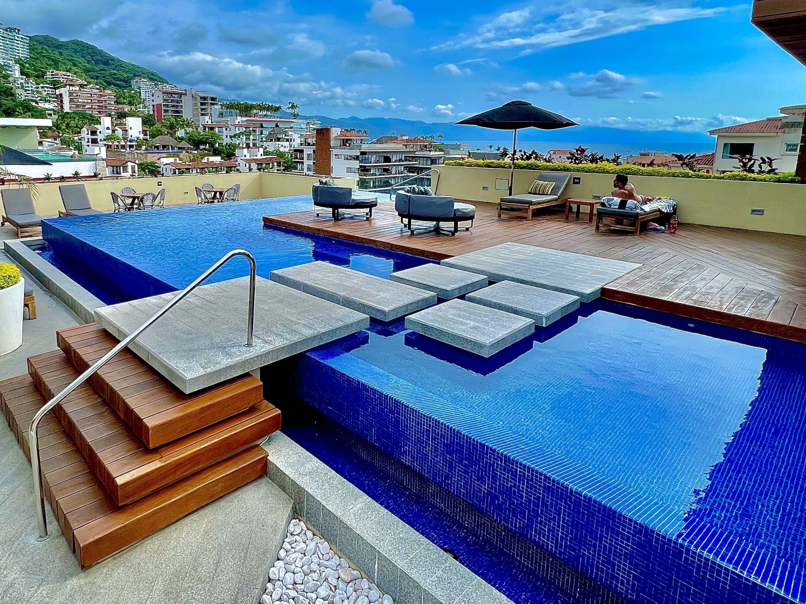 A rooftop infinity pool with a view of the city and mountains. - Pavilion Paradise - Steps away from everything! (Puerto Vallarta)