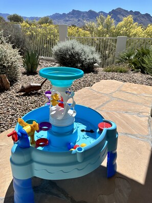 Children can play and splash in the water play area with a fountain and interactive toys.