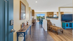 A spacious living area with a kitchen, dining area, and a view of the outdoors. - Incredible VIEWS, pool, spa, ping pong table, by GOLF course, bike and walk path (Tucson)