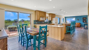 A spacious kitchen with a large island, wooden cabinets, and a view of the outdoors. - Incredible VIEWS, pool, spa, ping pong table, by GOLF course, bike and walk path (Tucson)