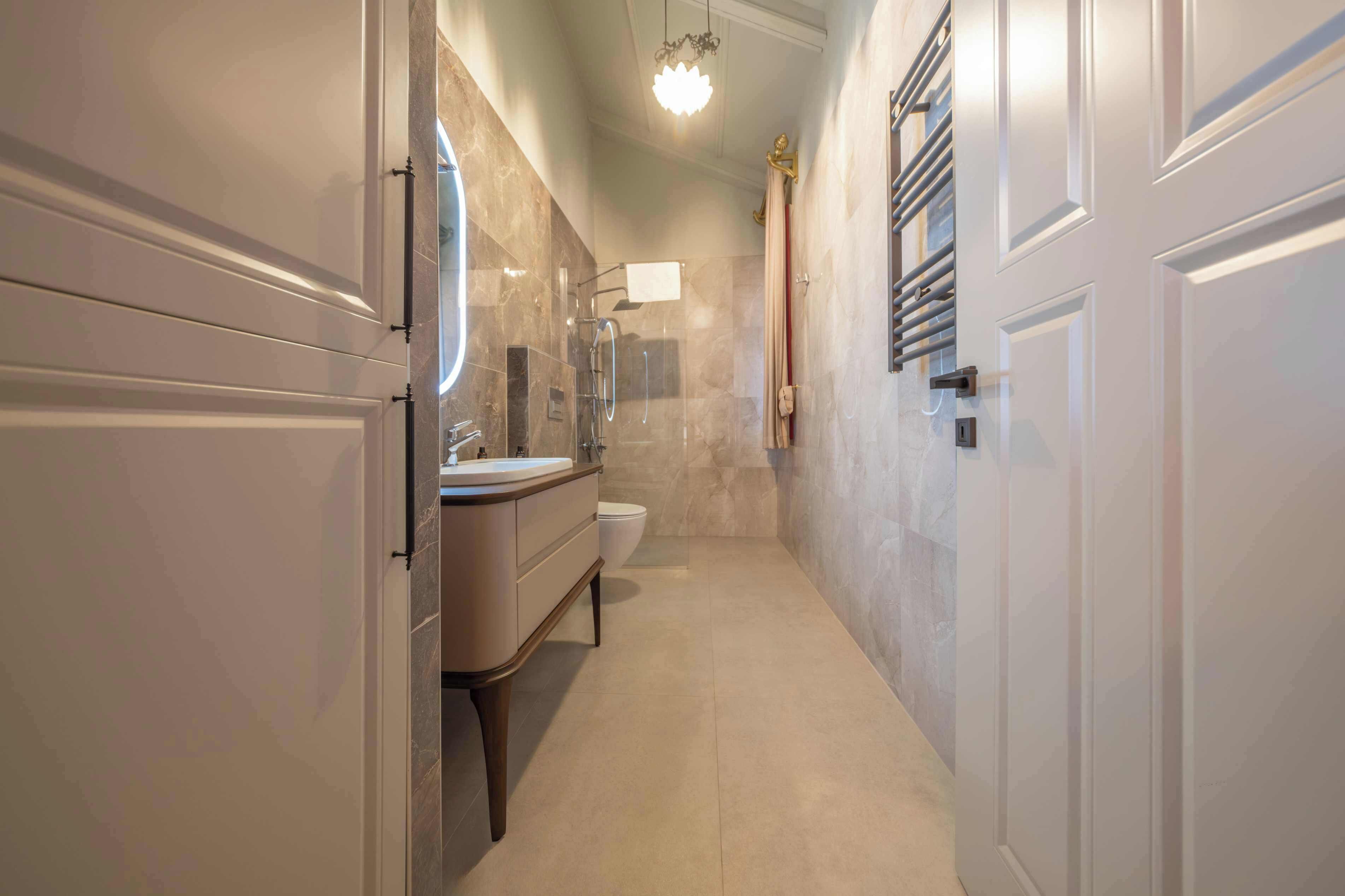 A modern bathroom with a vanity, sink, and toilet.