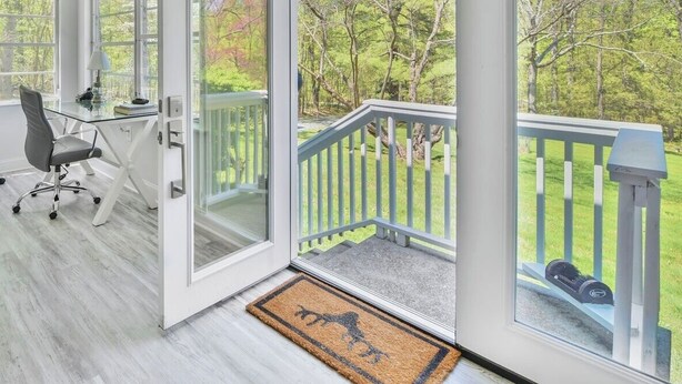 A spacious room with a large sliding glass door leading to a balcony with a view of trees. - Peaceful Mountain Retreat Near Appalachian Trail, Wineries, Breweries and More (Bluemont)