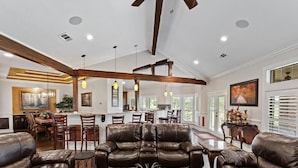 A spacious living area with leather sofas, a coffee table, and pendant lighting. - Newly Renovated Private Ranch Get-A-Way (Pilot Point)