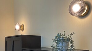 A dark wooden cabinet with a potted plant hanging from the top.