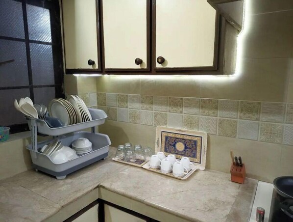 Functional kitchen with ample storage and a stylish backsplash.