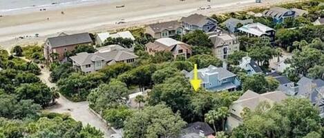 Vista aérea de una zona residencial costera con casas, una playa y una carretera.