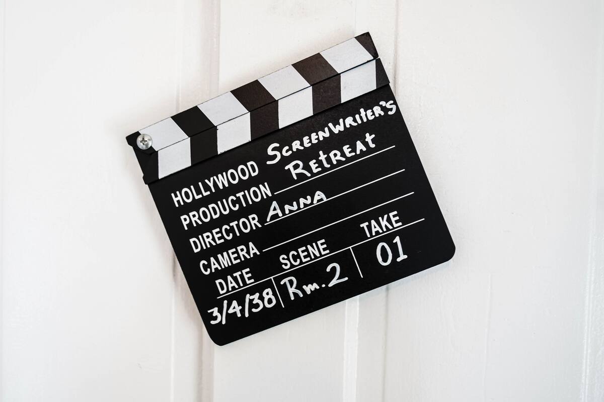 A clapperboard with text indicating a Hollywood screenplay retreat, directed by Anna, scheduled for 3/4/38, take 01.