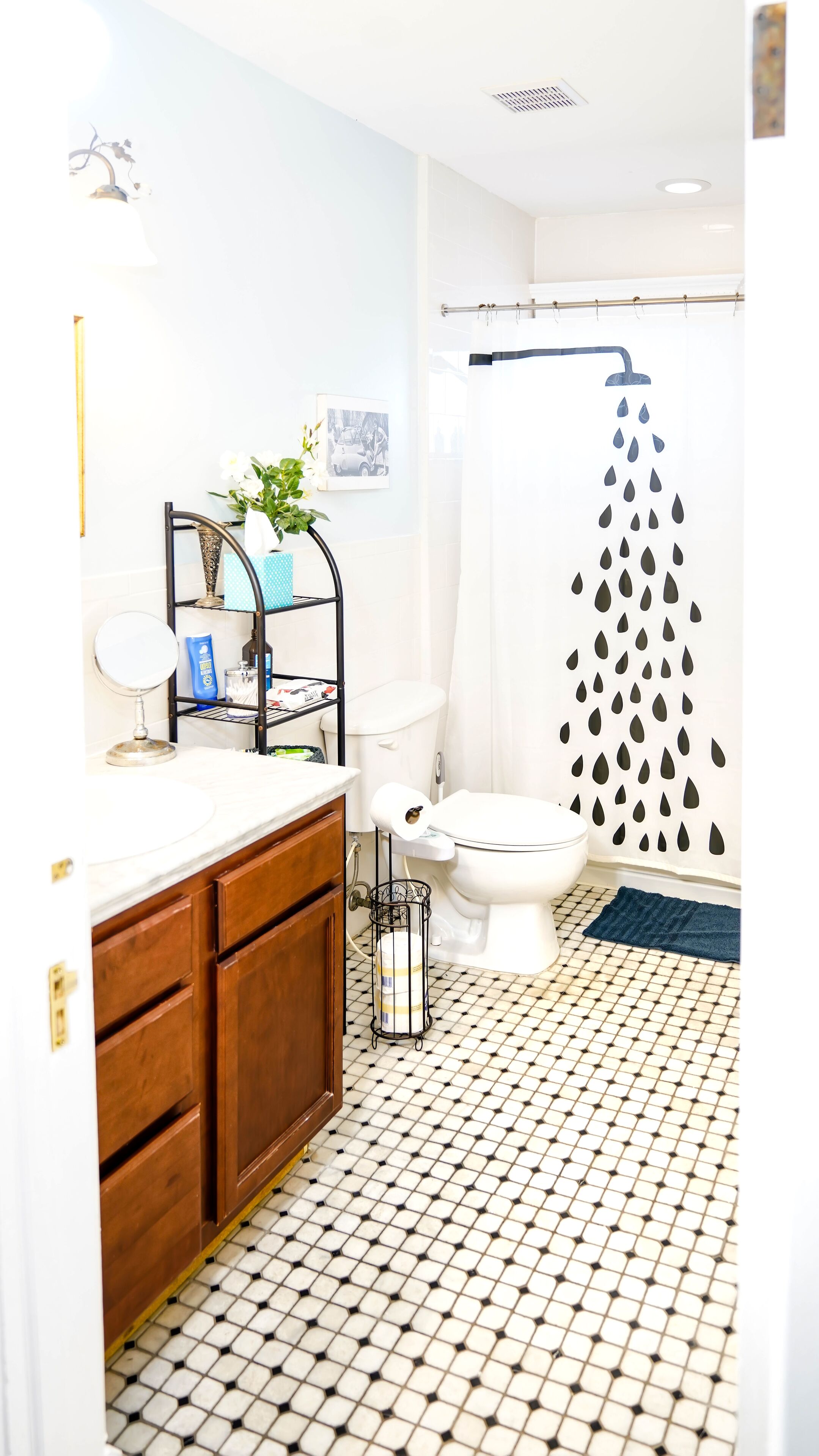 A bathroom with a toilet, sink, and shower area.