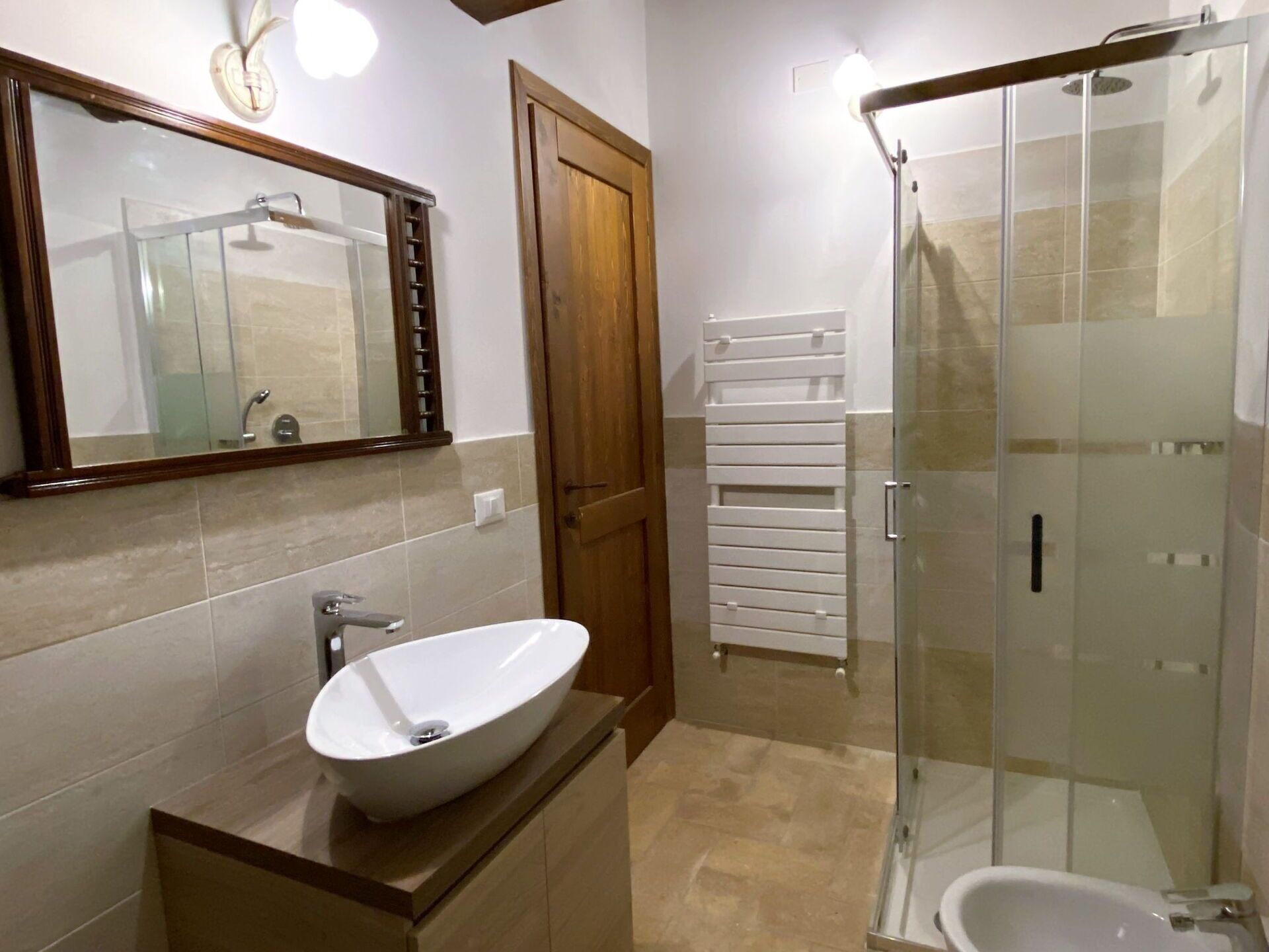 A bathroom with a freestanding bathtub, a glass-enclosed shower, and a toilet.