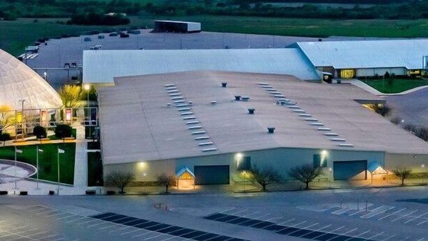 A large building with a dome and a flat-roofed section, likely a convention center or exhibition hall. - The CountryLake - First Floor for 7 Guest  (Belton)
