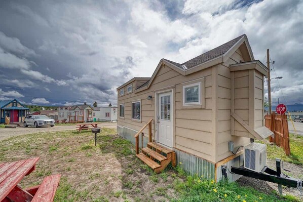 A single-story mobile home with a front porch and a small attached garage.