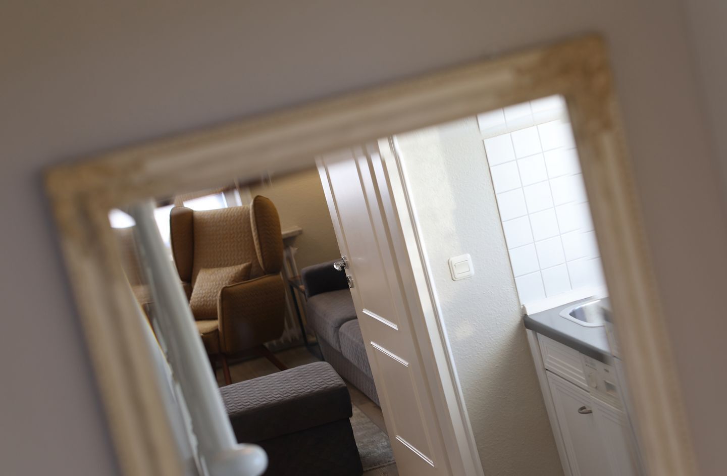 A compact room with a bed, a small table, and a window.