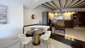 A modern kitchen with a central island, white cabinetry, and stainless steel appliances. - Rental apartment with sea view in Aiguafreda, Begur (Begur)