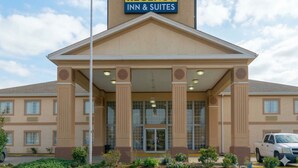 A Regency Inn & Suites building with a prominent entrance, large windows, and a clear sky. - Regency Inn & Suites Houston East I 10 (Houston)