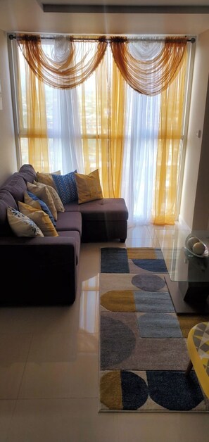 Relax in this stylish living room with a comfortable sofa, coffee table, and plush rug.
