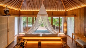 A room with a canopy bed, wooden walls, and large windows. - Kappa Senses Ubud (Ubud)