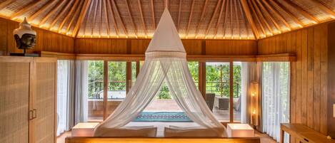 A room with a canopy bed, wooden walls, and large windows.