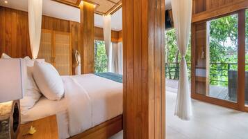 A bedroom with a wooden floor, a bed with white bedding, and a large window with curtains.