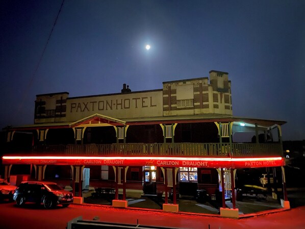 A two-story building with signage for "Paxton Hotel" and "Carlton Draught." - Paxton Hotel (Paxton)