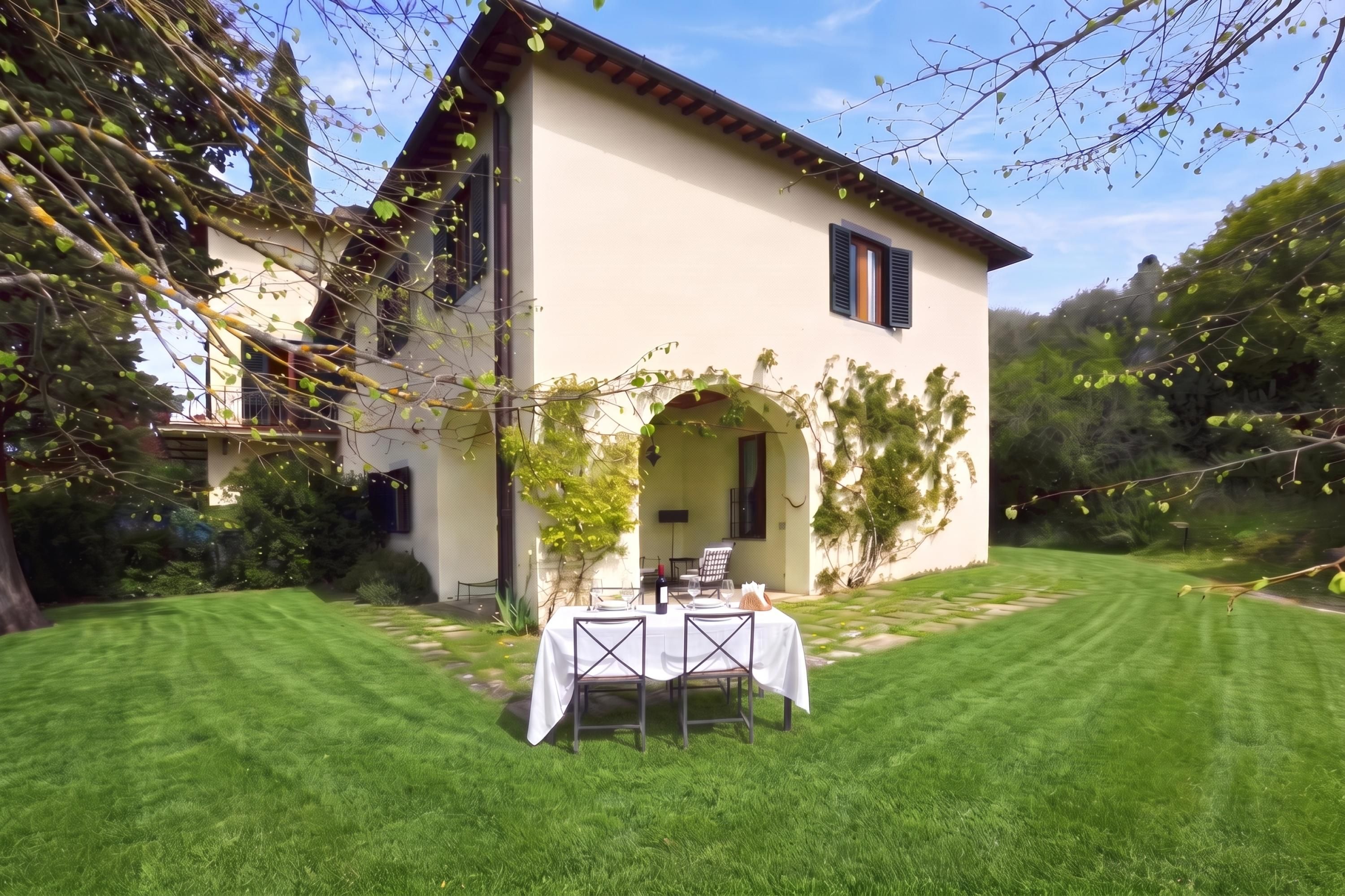 A house with a dining area set up outside, featuring a table and chairs.