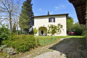 A two-story building with a white facade, a small arched entrance, and a window with shutters. - Certosa 4, Firenze, Italy (Firenze)