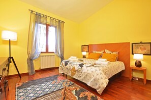 A hotel room with a bed, bedside lamps, a window with curtains, a radiator, and a rug. - Certosa 4, Firenze, Italy (Firenze)