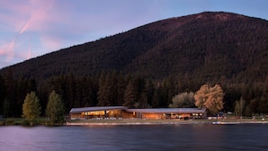 A lakeside lodge with a long building, a dock, and a forested mountain in the background. - Modern Black Butte Abode (Sisters)