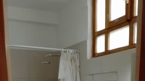 A bathroom with a shower, toilet, and sink.