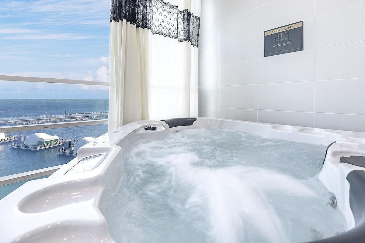 A hot tub with a view of a marina and boats.
