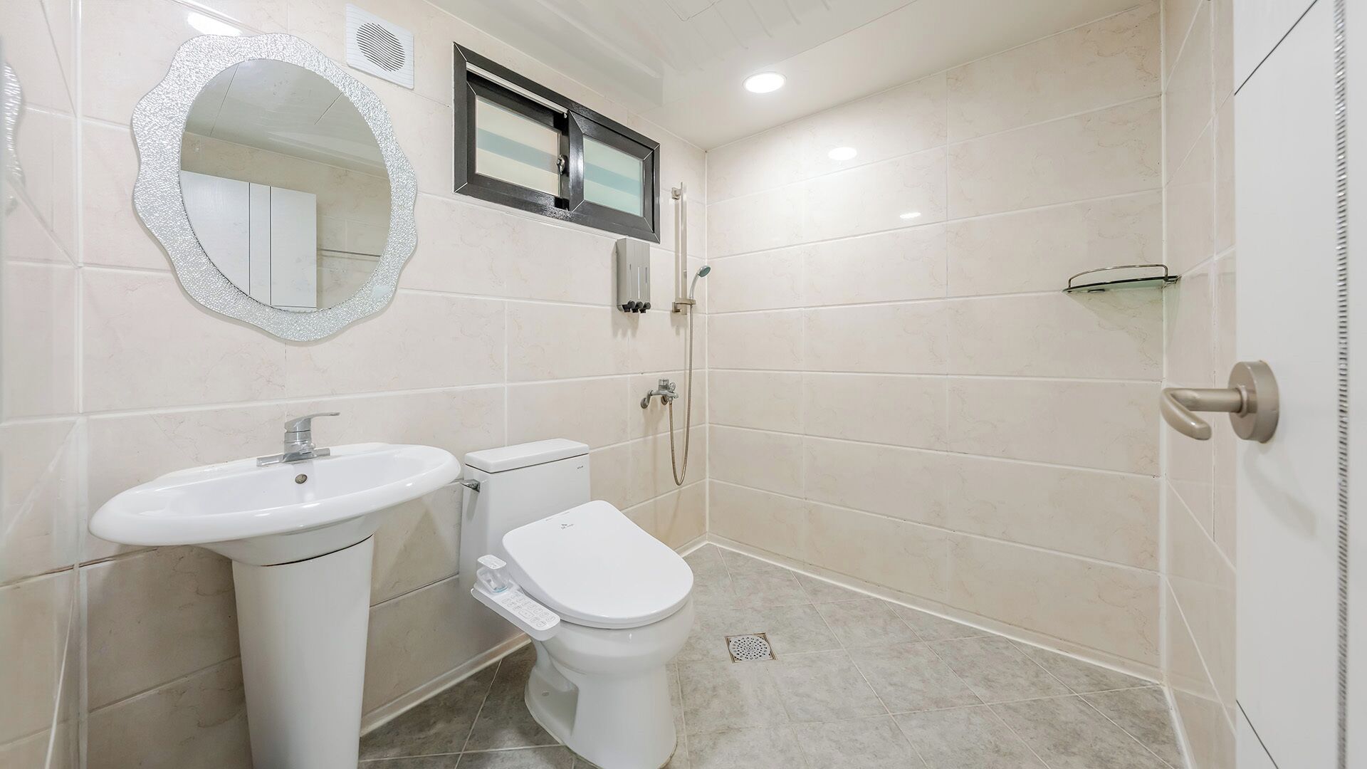A bathroom with a sink, toilet, and shower.