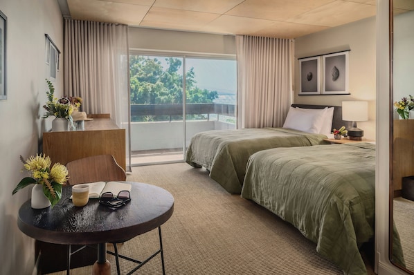 A hotel room with a bed, a desk, a chair, a table, and a view of the outdoors. - PACIFIC 19 Kona (Kailua-Kona)