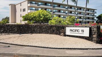A multi-story building with a sign reading 'PACIFIC 19' indicating a hotel or resort.